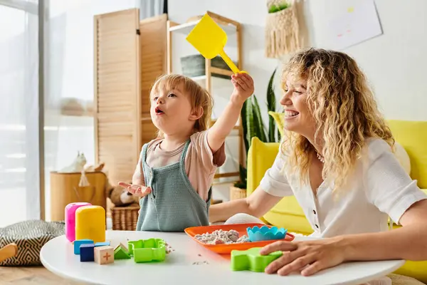 stock image A curly mother and her toddler daughter enjoying quality playtime using Montessori method of education at home.