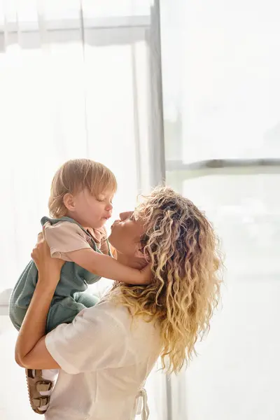 Curly Mother Cradling Her Toddler Daughter Loving Embrace Home — Stock Photo, Image