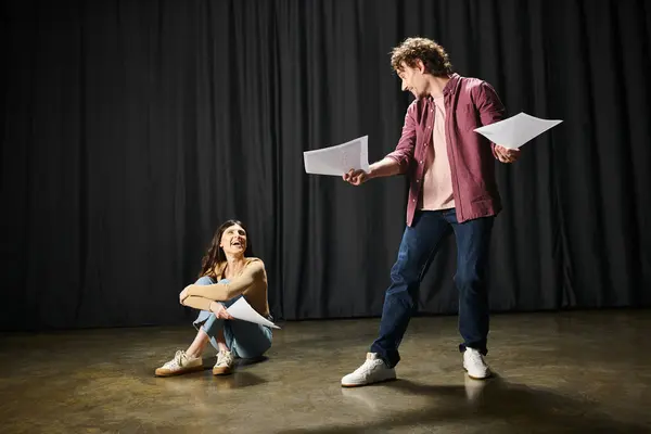 stock image A man and woman working on their lines together during theater rehearsals.