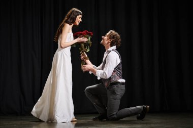 A man kneeling next to a woman in a white dress. clipart