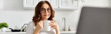 Middle aged woman enjoying a quiet moment with her coffee. clipart