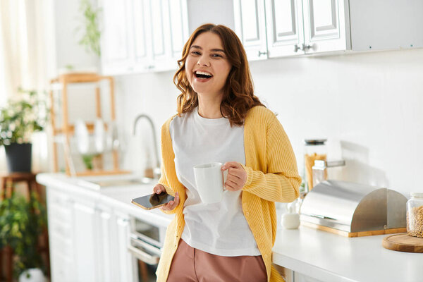 Middle-aged woman with coffee in kitchen.