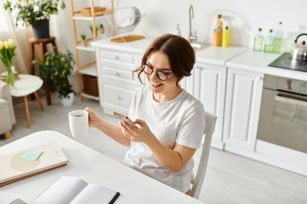 A middle-aged woman enjoys a quiet moment, sipping coffee at a table.
