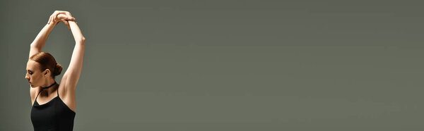 Young, beautiful ballerina passionately performs in a stunning black leo.