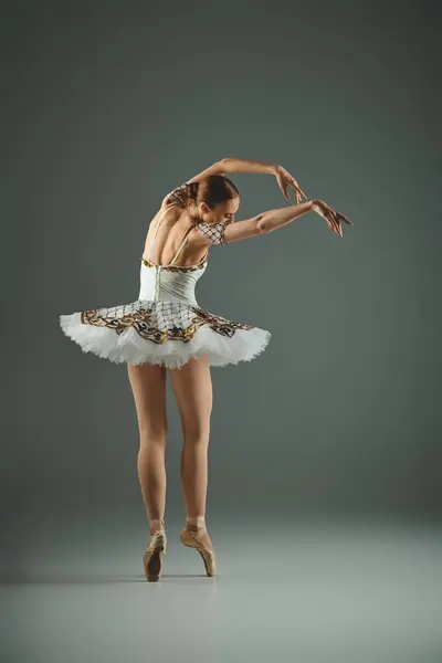 stock image Talented ballerina strikes a graceful pose in a white tutu.