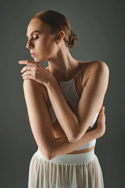 stock image Young woman in elegant white dress gracefully poses for a portrait.