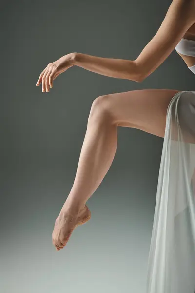 stock image A young beautiful ballerina in a white dress poses gracefully for a picture.