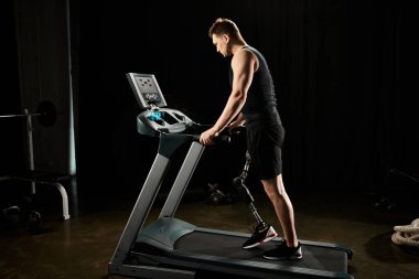 Loş ışıklı spor salonundaki koşu bandında protez bacak egzersizi yapan bir adam..