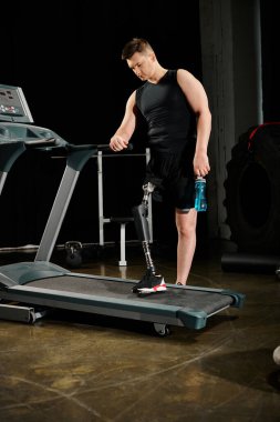 A disabled man with a prosthetic leg is standing and exercising on a treadmill in a dimly lit room. clipart