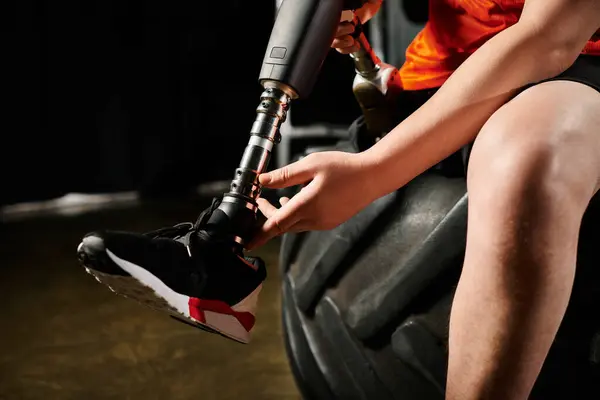 Person Prosthetic Leg Sits Top Tire Enjoying Moment Peace Contemplation — Stok fotoğraf