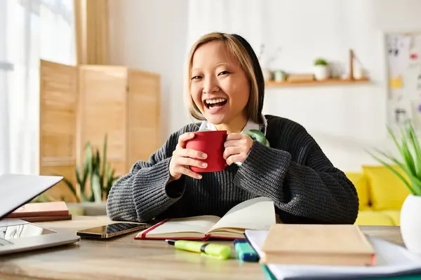 Young Asian Woman Focusing Her Studies Holding Vibrant Red Cup — Stock Photo, Image