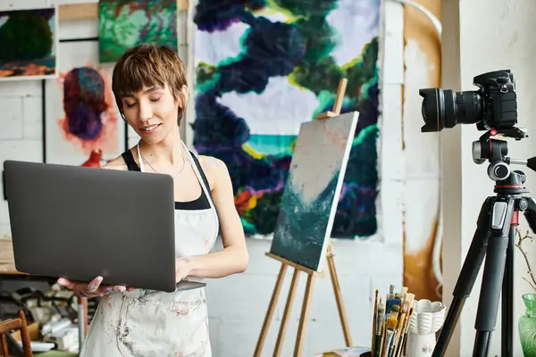 Woman Holds Laptop Front Painting — стоковое фото