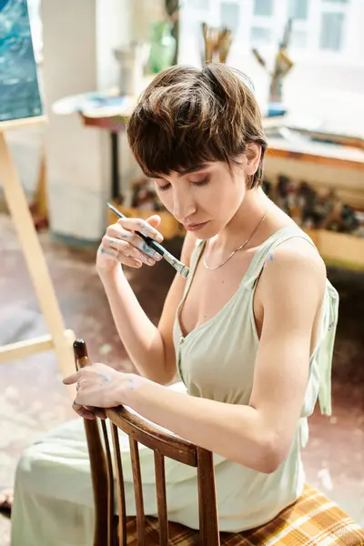 Woman Seated Chair Delicately Holding Brush — Stock Photo, Image