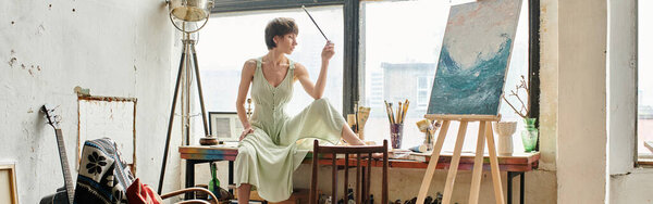 A woman sitting in front of a painting.