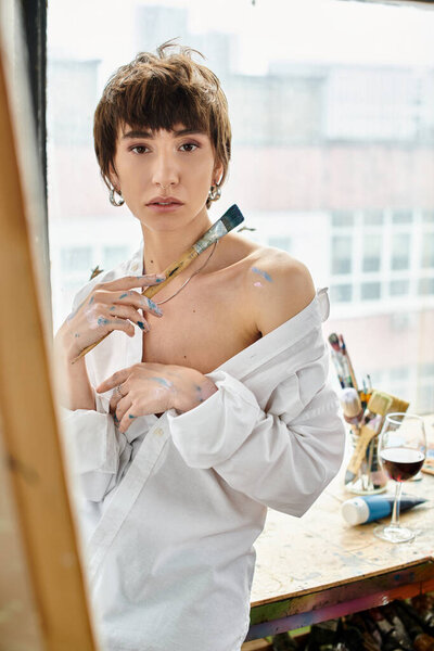 A woman stands before a camera, contemplating her beauty and style.