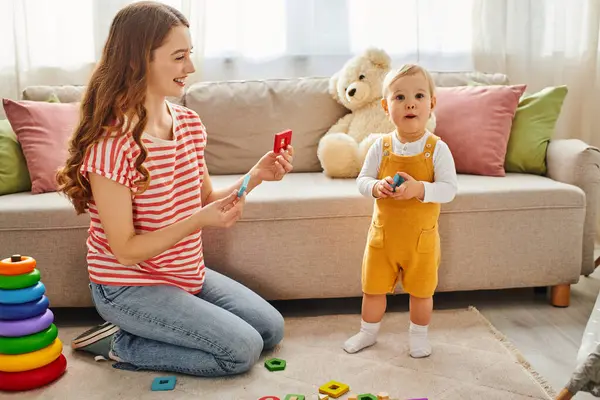 Young Mother Joyfully Sits Floor Playing Her Toddler Daughter Creating — Stock Photo, Image