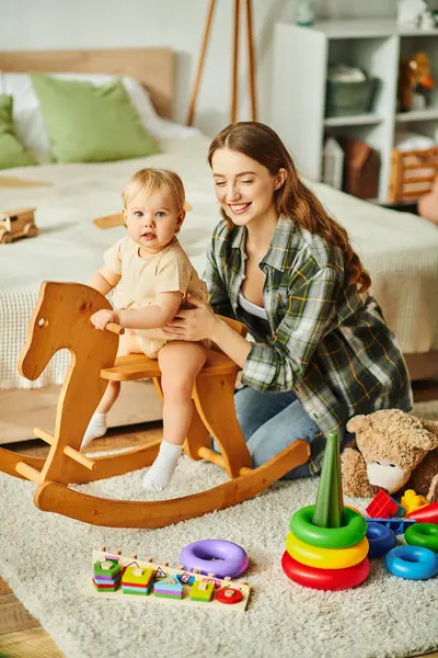 Young Mother Joyfully Plays Her Toddler Daughter Rocking Horse Sharing — Stock Photo, Image