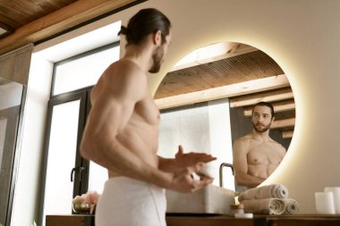 Handsome man in bathroom, engaging in morning skincare routine and grooming in front of mirror. clipart