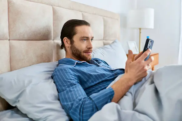 Man Peacefully Meditates Bed Cell Phone Hand — Stock Photo, Image