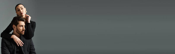 A man in elegant attire posing with his female partner.