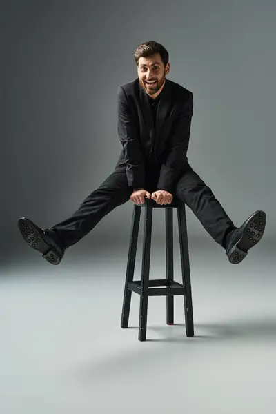 Man Elegant Attire Sits Top Stool —  Fotos de Stock