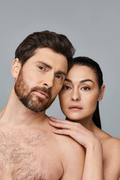 A man and a woman, showcasing their magnetic beauty while posing for a picture.