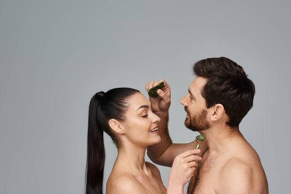 Loving couple, radiating beauty, using face roller and gua sha together.