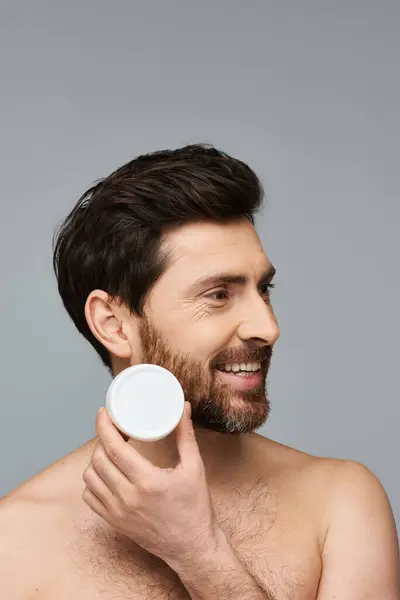 Bearded Man Gracefully Holds Jar Cream — Stock Photo, Image