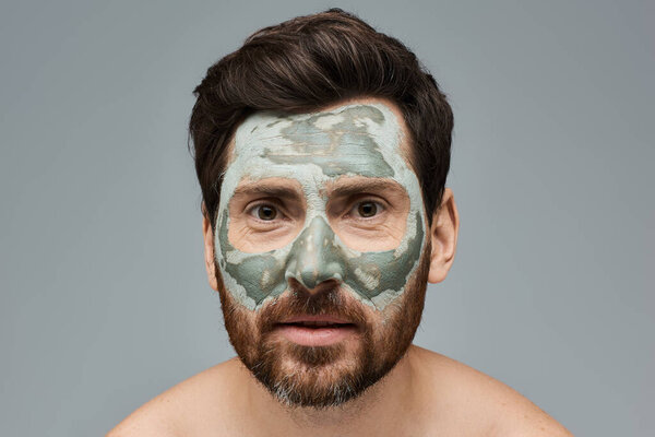 Bearded man wearing a facial mask, skincare.
