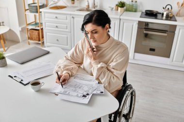 A disabled woman in a wheelchair reads a paper while working remotely from her kitchen. clipart