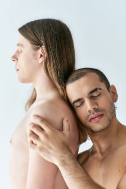 Shirtless two men in a moment of intimacy. clipart