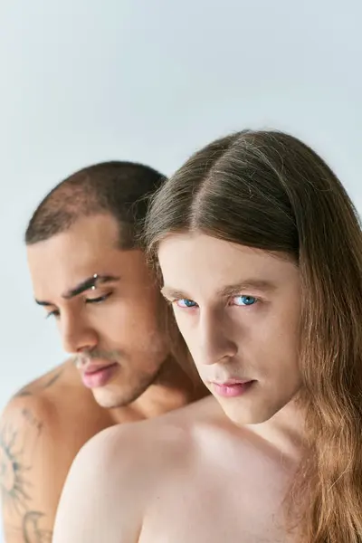 stock image Two men gaze at each other in the mirror.