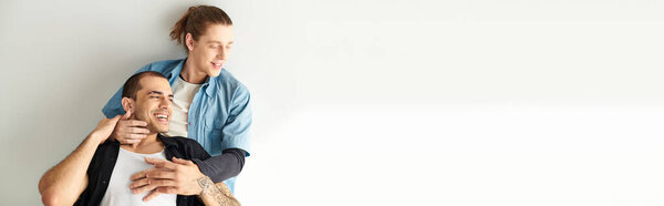 A man holds another man on his shoulders, showcasing strength and unity.