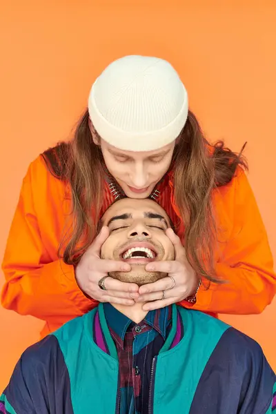 Young Man Hugging His Boyfriends Head Orange Backdrop — Stock Photo, Image