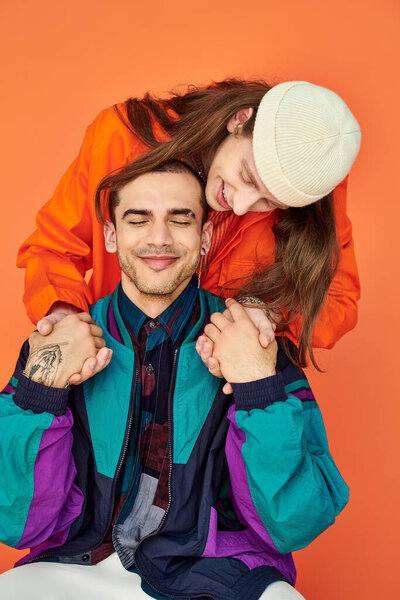 A graceful man stands atop another, creating a striking image of unity and strength.