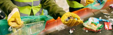 A young eco-conscious volunteer wearing yellow gloves sorting trash, holding a plastic bag in a community clean-up effort.