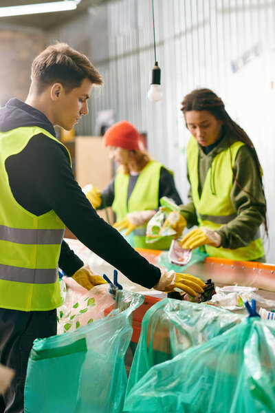 Young volunteers in gloves and safety vests, standing around a table filled with bags, sorting trash together.