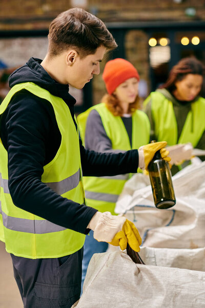 A man elegantly holds a bottle of wine in his hands.