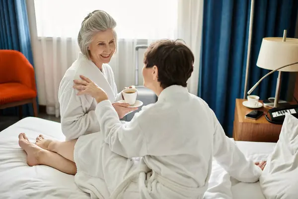 Two Women White Robes Sit Intimately Bed — Foto Stock