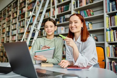 a tutor and a teenage girl, immersed in modern education, using a laptop in a cozy library setting. clipart