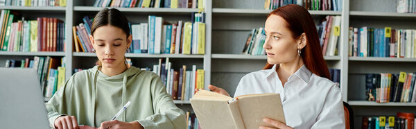 A tutor with red hair teaches a teenage girl in a library among tall bookcases, with a laptop open for modern education.