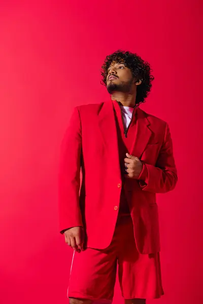 stock image Handsome young Indian man in a striking red suit, exuding confidence and style.