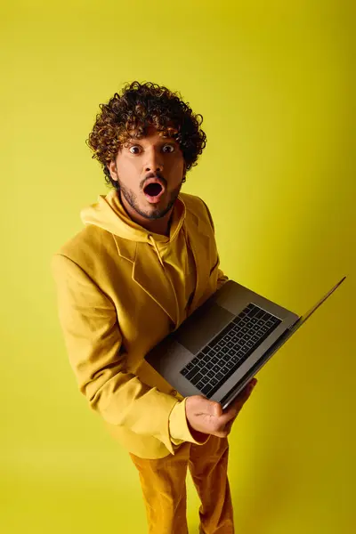 Handsome Young Indian Man Curly Hair Holding Laptop Vibrant Backdrop — ストック写真