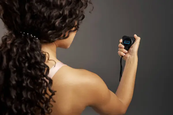 Woman Curly Hair Holding Timer Looking Engaged Screen — Stockfoto