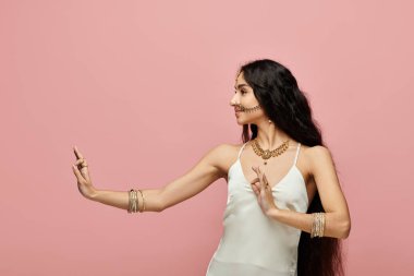 Young indian woman in a white dress posing actively. clipart