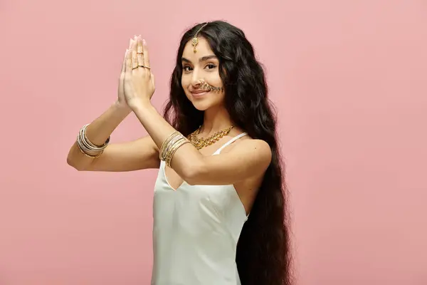 stock image A young indian woman with long hair striking a graceful pose.