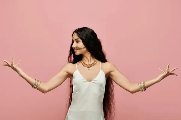 stock image Young indian woman in white dress stretching out her arms gracefully.