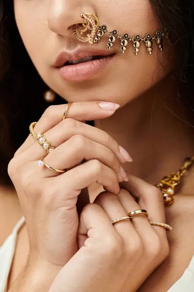 stock image A young indian woman exudes beauty and confidence with a shimmering gold nose ring.