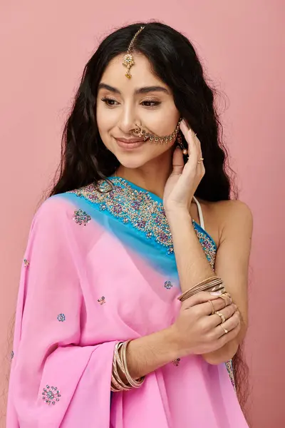 stock image Elegant indian woman in a vibrant pink sari posing gracefully.