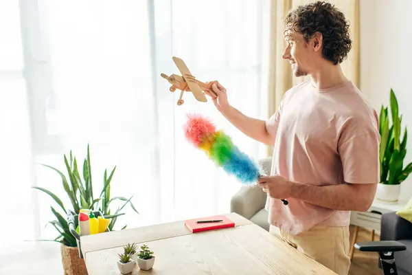 Man Cozy Homewear Playing Toy Airplane While Cleaning Home — Foto Stock